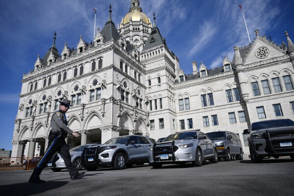 FILE - Police vehicles are stationed outside the Connecticut State Capitol on the opening session of legislature, Feb. 7, 2024, in Hartford, Conn. Facing a Dec. 31 deadline, Connecticut lawmakers were on track Tuesday, May, 7, 2024, to approve a Democratic plan to spend at least $360 million in remaining federal COVID-19 pandemic funds on key areas, including higher education, not-for-profit social service agencies, municipal aid and children's mental health. (AP Photo/Jessica Hill, File)