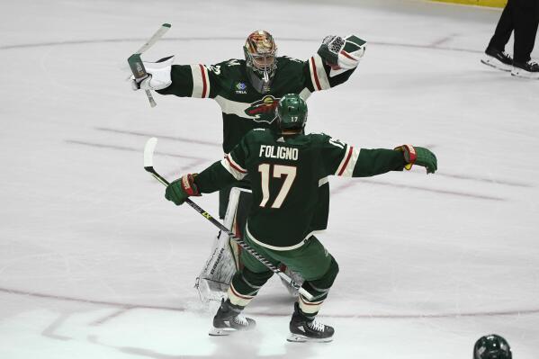 Minnesota Wild goalie Filip Gustavsson (32) celebrates with left wing Marcus Foligno (17) after defeating the Anaheim Ducks in a shootout in an NHL hockey game Saturday, Dec. 3, 2022, in St. Paul, Minn. (AP Photo/Craig Lassig)