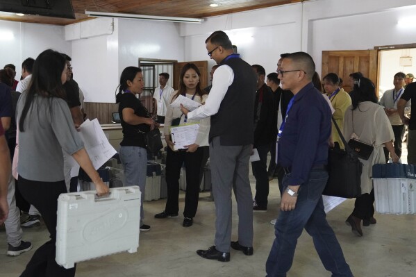 Kumar Ramnikant, Deputy Commissioner of Kohima district, centre, speaks with polling officers during distribution of election related material in Kohima, in the northeastern Indian state of Nagaland, Thursday, April 18, 2024. (AP Photo/Yirmiyan Arthur)