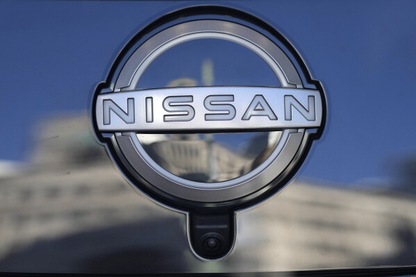 FILE - A Nissan logo is seen on a car at its showroom in Tokyo, Feb. 21, 2023. Nissan is recalling more than 236,000 small cars in the U.S. because the tie rods in front suspension can bend and break, possibly causing drivers to lose steering control. The recall covers certain Sentra cars from 2020 through 2022. (AP Photo/Shuji Kajiyama, File)