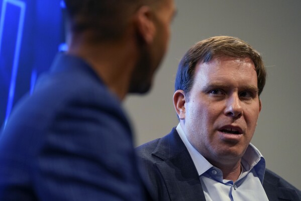 Dallas Mavericks governor Patrick Dumont, right, speaks during an NBA basketball availability alongside general manager Nico Harrison, Friday, June 14, 2024, in Dallas, Texas. (AP Photo/Sam Hodde)