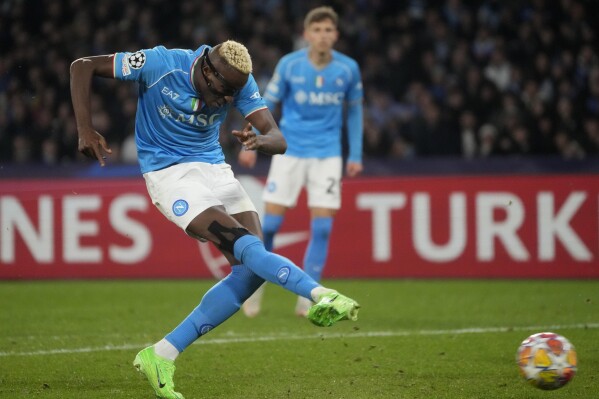 Napoli's Victor Osimhen scores his side's opening goal during the Champions League, round of 16, first leg soccer match between SSC Napoli and FC Barcelona at the Diego Maradona stadium in Naples, Italy, Wednesday, Feb. 21, 2024. (APPhoto/Gregorio Borgia)