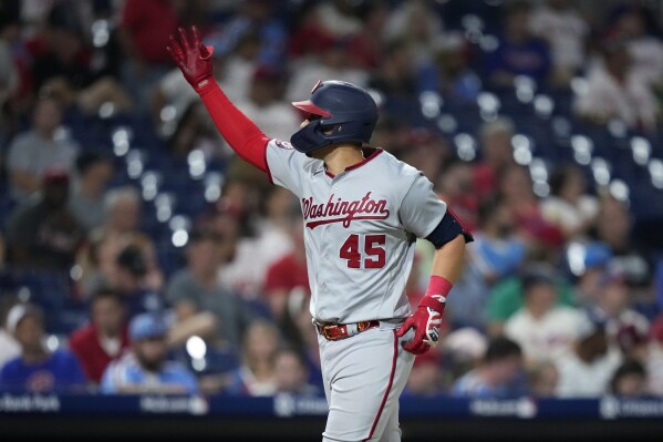 Washington Nationals' Joey Meneses react after hitting a two-run home run against Philadelphia Phillies pitcher Jeff Hoffman during the seventh inning of the second baseball game in a doubleheader, Tuesday, Aug. 8, 2023, in Philadelphia. (AP Photo/Matt Slocum)
