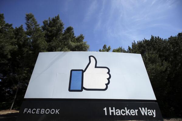FILE - In this April 14, 2020 file photo, the thumbs up Like logo is shown on a sign at Facebook headquarters in Menlo Park, Calif, USA.  Facebook's purchase of Giphy will hurt competition for animated images, U.K. regulators said Thursday Aug. 12, 2021, following an investigation, indicating the social network could be forced to sell off the company if the provisional finding's concerns are confirmed.  Giphy's library of short looping videos, or GIFs, are a popular tool for internet users sending messages or posting on social media. (AP Photo/Jeff Chiu, File)