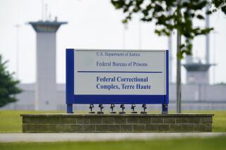 FILE - A sign is displayed at the federal prison complex in Terre Haute, Ind., Aug. 28, 2020. A judge tossed 49-year-old Bruce Webster's death sentence in accordance with a 2002 Supreme Court decision that executing anyone with an intellectual disability violated Eight Amendment protections against "cruel and unusual" punishment. After years of delays, his lawyers said Webster has been moved off death row to a less restrictive prison. (AP Photo/Michael Conroy, File)