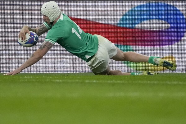 Ireland's Mack Hansen scores a try during the Rugby World Cup Pool B match between South Africa and Ireland at the Stade de France in Saint-Denis, outside Paris, Saturday, Sept. 23, 2023. (AP Photo/Christophe Ena)