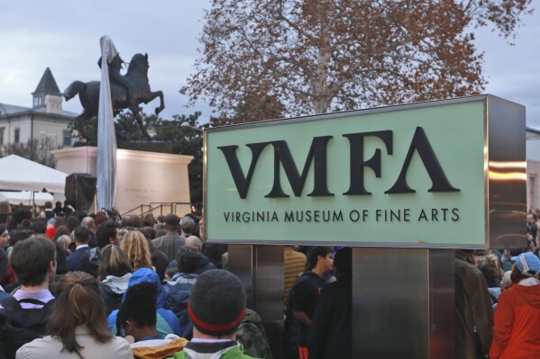 FILE - Spectators watch during the unveiling ceremony for a statue at the Virginia Museum of Fine Arts in Richmond, Va., Dec. 10, 2019. Virginia’s state-run fine arts museum is returning 44 ancient pieces of art to their countries of origin after law enforcement officials presented the institution with what it called “irrefutable evidence” that the works had been stolen or looted. The Virginia Museum of Fine Arts announced in a news release Tuesday, Dec. 5, 2023 that it had “safely delivered” the pieces to the Manhattan District Attorney’s Office. (APPhoto/Steve Helber, file)