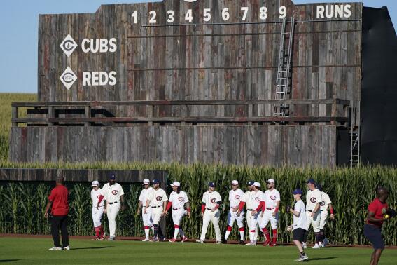 Chicago Cubs and Cincinnati Reds players walk onto the field before a baseball game at the Field of Dreams movie site, Thursday, Aug. 11, 2022, in Dyersville, Iowa. (AP Photo/Charlie Neibergall)