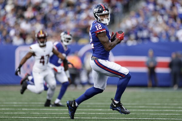 FILE - New York Giants tight end Darren Waller (12) makes a catch against the Washington Commanders during the first quarter of an NFL football game, Oct. 22, 2023, in East Rutherford, N.J. The Giants activated Waller from injured reserve and waived veteran safety Bobby McCain on Saturday, Dec. 16. (AP Photo/Adam Hunger, File)
