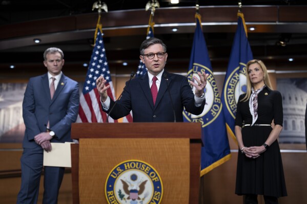 Speaker of the House Mike Johnson, R-La., center, flanked by Rep. Blake Moore, R-Utah, left, and Rep. Beth Van Duyne, R-Texas, discusses President Joe Biden for his policies at the Mexican border during a news conference at the Capitol in Washington, Thursday, Feb. 29, 2024. (AP Photo/J. Scott Applewhite)