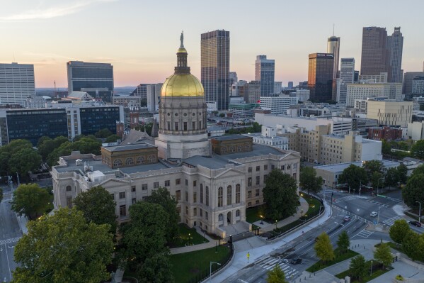 FILE - The gold dome of the Georgia Capitol gleams in the sunlight in Atlanta, Aug. 28, 2022. Under a $392 million plan agreed to on Monday, Feb. 26, 2024, the state Capitol would get a renovation while the state would build a new legislative office building for lawmakers on the north side of the complex, to the right of the Capitol. (AP Photo/Steve Helber, File)