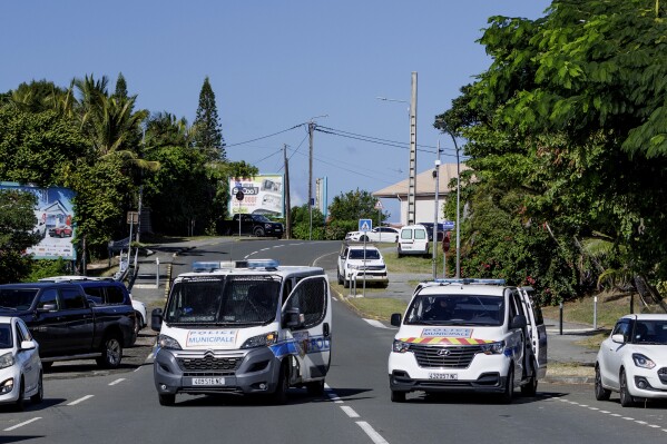 Municipal police vans patrol the streets in Noumea, New Caledonia, Thursday May, 16, 2024. France has imposed a state of emergency in the French Pacific territory of New Caledonia. The measures imposed on Wednesday for at least 12 days boost security forces' powers to quell deadly unrest that has left four people dead, erupting after protests over voting reforms. (AP Photo/Cedric Jacquot)