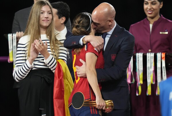 FILE - President of Spain's soccer federation, Luis Rubiales, right, hugs Spain's Aitana Bonmati on the podium following Spain's win in the final of Women's World Cup soccer against England at Stadium Australia in Sydney, Australia, Sunday, Aug. 20, 2023.The kiss by Luis Rubiales has unleashed a storm of fury over gender equality that almost marred the unprecedented victory but now looks set to go down as a milestone in both Spanish soccer history but also in women's rights. (AP Photo/Alessandra Tarantino, file)