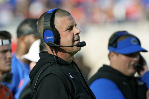 Florida head coach Billy Napier watches play during the first half of an NCAA college football game against Georgia, Saturday, Oct. 28, 2023, in Jacksonville, Fla. (AP Photo/John Raoux)