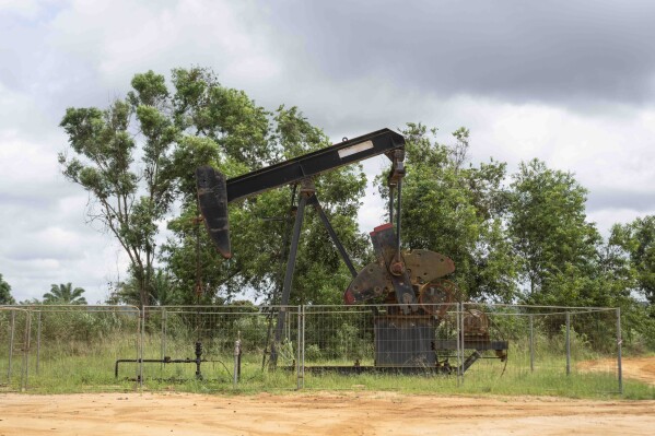 An oil drilling structure operates near the village of Kinkazi, outside Moanda, Democratic Republic of the Congo, Sunday, Dec. 24, 2023. The country is looking to expand the oil drilling. (AP Photo/Mosa'ab Elshamy)