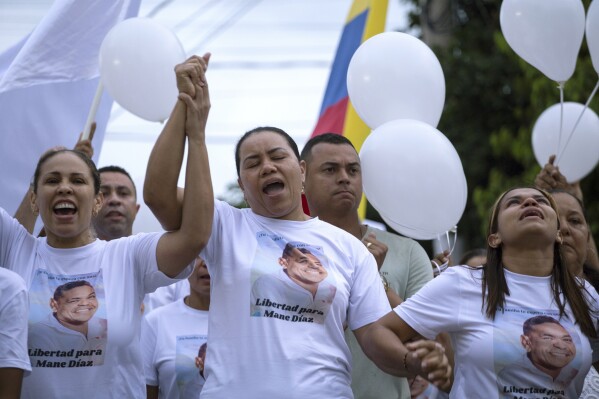 Cilenis Marulanda, center, mother of Liverpool soccer player Luis Diaz takes part in a march to ask for the release of her husband in Barrancas, La Guajira department, Colombia, Tuesday, Oct. 31, 2023. Diaz' parents were abducted by armed men on Oct. 28. Marulanda was freed within hours, but the soccer star father remains missing. (AP Photo/Leo Carrillo)