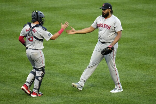 Boston Red Sox relief pitcher Kenley Jansen, right, celebrates with catcher Reese McGuire after getting the final out of a 4-2 win over the Pittsburgh Pirates in a baseball game in Pittsburgh, Saturday, April 20, 2024. (AP Photo/Gene J. Puskar)