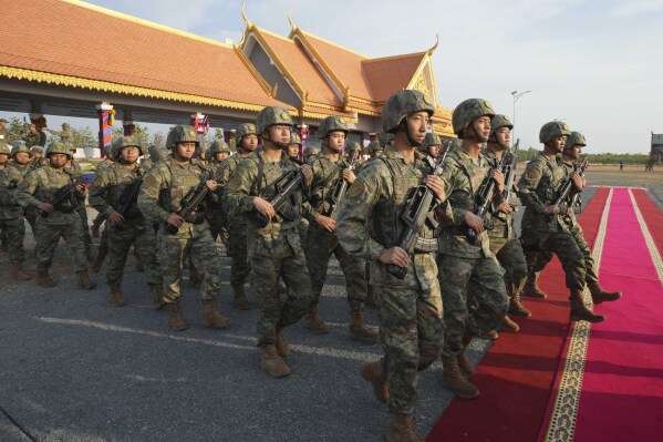 Chinese military personnel head to a field to participate in the Golden Dragon military exercise in Svay Chok village, Kampong Chhnang province, north of Phnom Penh Cambodia, Thursday, May 16, 2024. Cambodia and China on Thursday kicked off their annual Golden Dragon military exercise to strengthen cooperation and exchange military experiences. (AP Photo/Heng Sinith)