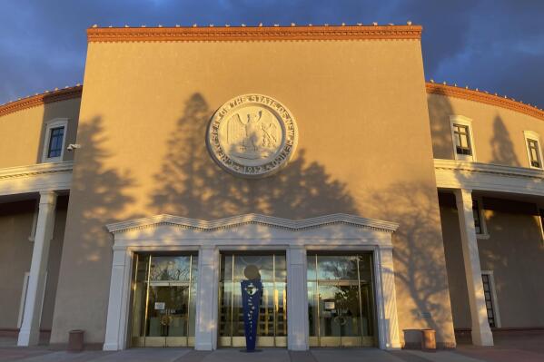 Afternoon sun shines on the New Mexico state Capitol building in Santa Fe, N.M., on Dec. 10, 2021. The state Legislature is scheduled to convene on Tuesday, Jan. 18, 2022, to consider critical decisions on spending, voting access, public education and criminal justice. (AP Photo/Morgan Lee)