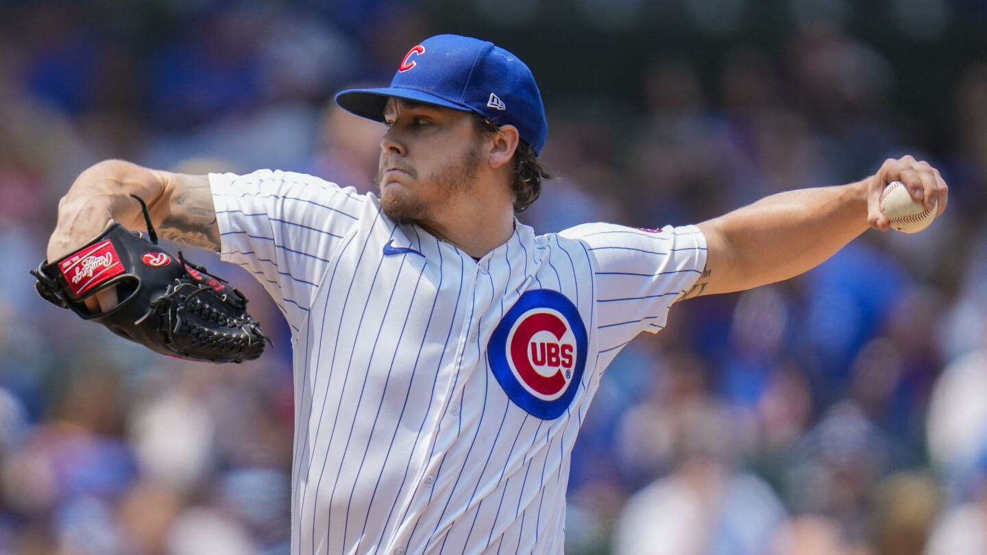 Chicago Cubs' Nico Hoerner, right, high-fives Chicago Cubs' Edwin