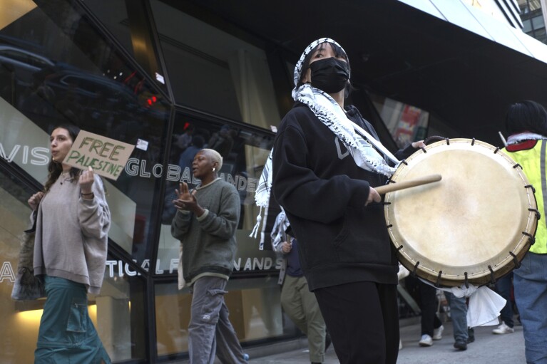 Demonstrators protest against the Israel-Hamas war in front of The New School university in New York on Monday, April 22, 2024. (AP Photo/Patrick Sison)