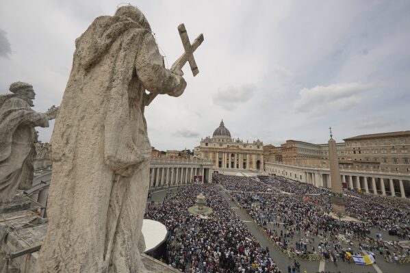Pope Leo XIV appears at the central balcony of St. Peter's Basilica for his first Sunday blessing after his election, in St. Peter's Square at the Vatican, Sunday May 11, 2025. (AP Photo/Alessandra Tarantino)