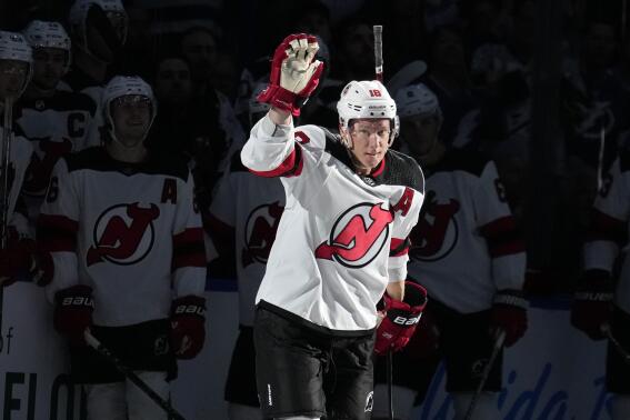 New Jersey Devils left wing Ondrej Palat (18) waves to the fans after a video tribute during the first period of an NHL hockey game against the Tampa Bay Lightning Sunday, March 19, 2023, in Tampa, Fla. Palat won two Stanley Cups with the Lightning. (AP Photo/Chris O'Meara)