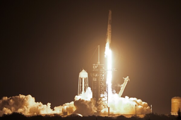 A SpaceX Falcon 9 rocket and Dragon capsule with a crew of four on a mission to the International Space Station lifts off from pad 39A at the Kennedy Space Center in Cape Canaveral, Fla., Sunday, March 3, 2024. (AP Photo/John Raoux)