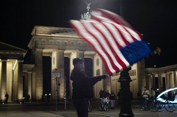 Marianne Hoenow from Connecticut in the US celebrates the victory of President-elect Joe Biden and Vice President-elect Kamala Harris in front of the Brandenbug Gate next to the United States embassy in Berlin, Germany, Saturday, Nov. 7, 2020. Biden defeated President Donald Trump to become the 46th president of the United States on Saturday, positioning himself to lead a nation gripped by the historic pandemic and a confluence of economic and social turmoil. (Photo/Markus Schreiber)