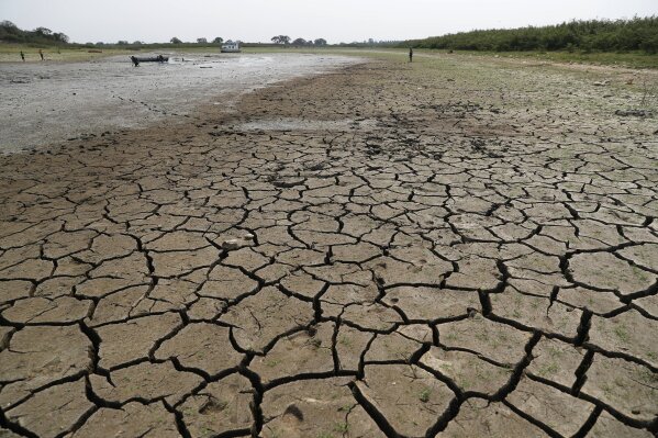 Cracked earth is exposed in the riverbed of the Paraguay River in Chaco-i near Asuncion city, Paraguay, Thursday, Oct. 8, 2020. The Paraguay River reached its lowest level in 50 years on Friday, Oct. 9, 2020, following months of extreme drought that has exposed the nation’s economic dependence on the river and limited access to drinking water. (AP Photo/Jorge Saenz)