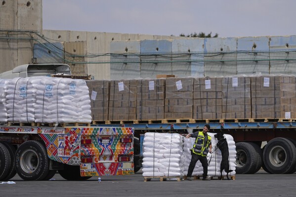 FILE - Trucks carrying humanitarian aid for the Gaza Strip pass through the inspection area at the Kerem Shalom Crossing in southern Israel, Thursday, March 14, 2024. (AP Photo/Ohad Zwigenberg, File)