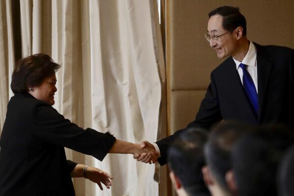 CORRECTS FILIPINO'S ID - Filipino Foreign Affairs Undersecretary Theresa Lazaro, left, and Chinese Vice Foreign Minister Sun Weidong shake hands during a bilateral meeting in Manila, Philippines on Friday March 24, 2023. (Francis Malasig/Pool Photo via AP)