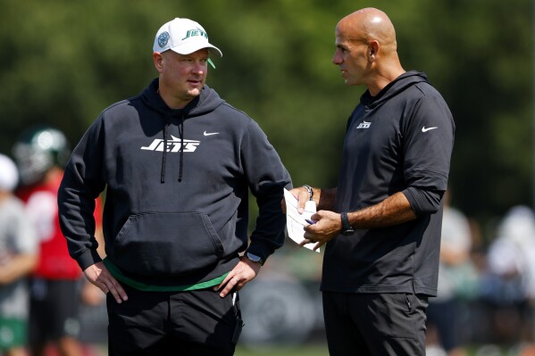 New York Jets offensive coordinator Nathaniel Hackett talks wit head coach Robert Saleh during the team's NFL football training camp, Saturday, July 27, 2024, in Florham Park, N.J. (AP Photo/Rich Schultz)