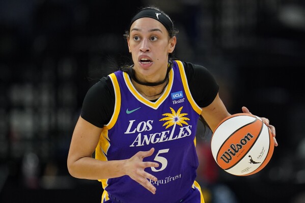 FILE - Los Angeles Sparks forward Dearica Hamby dribbles down the court during the first half of a WNBA basketball against the Minnesota Lynx, game Sunday, June 11, 2023, in Minneapolis. Dearica Hamby filed a gender discrimination complaint last week against the WNBA and the Las Vegas Aces, saying her former team and its coach, Becky Hammon, retaliated against her after she informed them she was pregnant. Hamby filed the complaint with the Nevada Equal Rights Commission and the Equal Employment Opportunity Commission, according to a copy of the complaint obtained by 花椒直播 on Thursday, Oct. 5, 2023. (AP Photo/Abbie Parr, File)