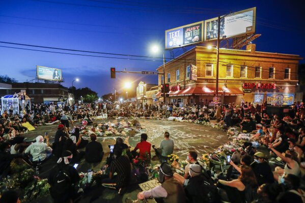 Protesters gather at a memorial for George Floyd where he died outside Cup Foods on East 38th Street and Chicago Avenue, Monday, June 1, 2020, in Minneapolis. Protests continued following the death of Floyd, who died after being restrained by Minneapolis police officers on May 25. (AP Photo/John Minchillo)