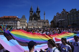 FILE - People march during the LGBTQ+ parade at the Old Town Square in Prague, Czech Republic, Saturday, Aug. 12, 2023. On Tuesday May 7, 2024 , the Czech Republic's highest legal authority ruled to dismiss part of a law requiring people to undergo surgery, including sterilisation and change of sexual organs, to be able to officially change their gender. (AP Photo/Petr David Josek, File)