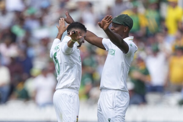 South Africa's Keshav Maharaj, left, celebrates with teammate Kagiso Rabada after the dismissal of Australia's Alex Carey during the World Test Championship final between South Africa and Australia at Lord's cricket ground in London, Wednesday, June 11, 2025. (AP Photo/Kirsty Wigglesworth)