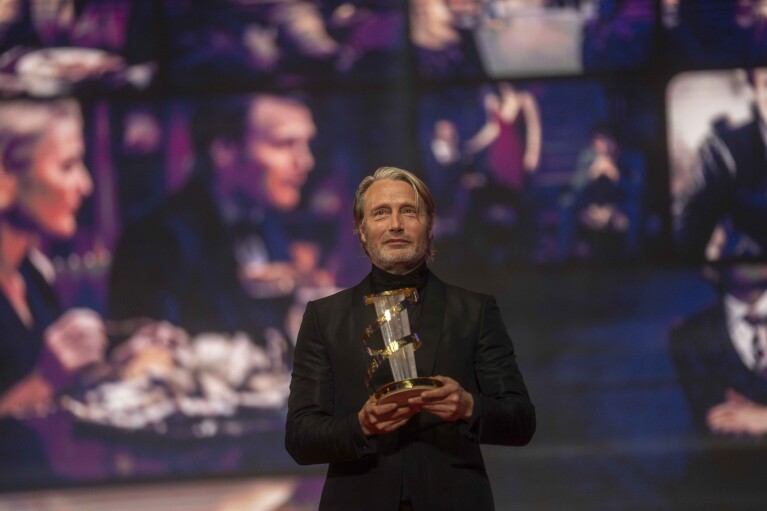 Mads Mikkelsen receives the tribute award during the opening ceremony of the 20th Marrakech International Film Festival, in Morocco, Friday, Nov. 24, 2023. (AP Photo/Mosa'ab Elshamy)