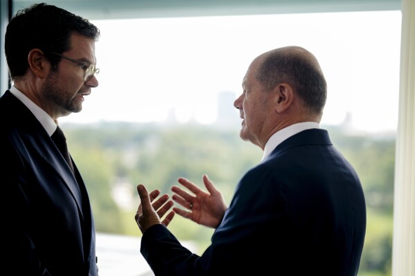 German Chancellor Olaf Scholz, right, speaks with German Justice Minister Marco Buschmann during the cabinet meeting of the German government at the chancellery in Berlin, Germany, Wednesday, Aug. 23, 2023. (AP Photo/Markus Schreiber)