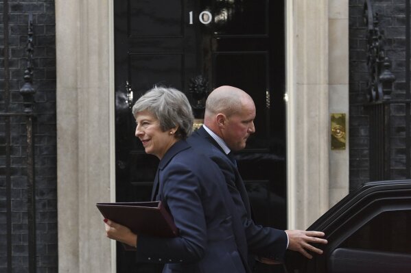 
              British Prime Minister Theresa May smiles outside 10 Downing Street, London, Wednesday, Nov. 14, 2018. British Prime Minister Theresa May is set to face her divided Cabinet in a bid to win support for a draft Brexit deal with the European Union. Negotiators from the two sides have reached agreement on divorce terms, including a plan to resolve the key issue of the Irish border. (Stefan Rousseau/PA via AP)
            