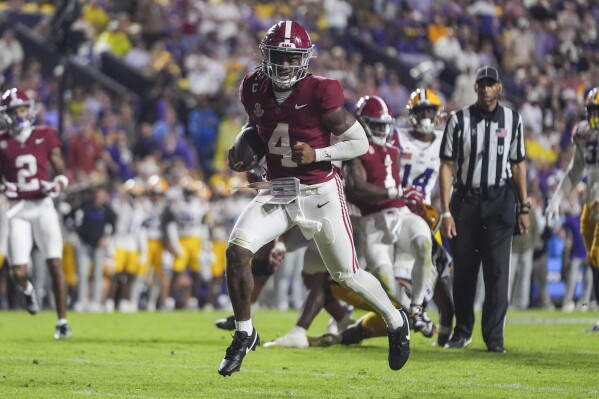 Alabama quarterback Jalen Milroe (4)crosses the goal line on a touchdown carry in the second half an NCAA college football game against LSU in Baton Rouge, La., Saturday, Nov. 9, 2024. (AP Photo/Gerald Herbert)