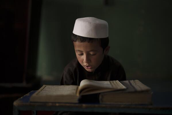An Afghan student reads the Quran, Islam's holy book, at a madrasa in Kabul, Afghanistan, Tuesday, Sept. 28, 2021. (AP Photo/Felipe Dana)