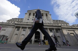 FILE - A man walks past the Bank of England, at the financial district in London, on May 11, 2023. The Bank of England is poised to raise borrowing costs again on Thursday June 22, 2023, to combat stubbornly high inflation, which has failed to come down from its peak as quickly as expected. (AP Photo/Frank Augstein, File)
