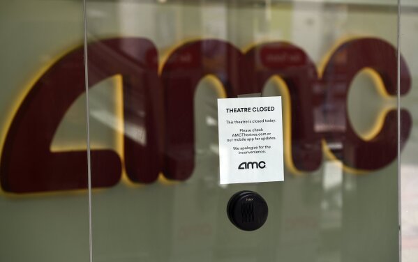 A message on the ticket window at the AMC Burbank 16 movie theaters complex informs potential customers that it is currently closed, Wednesday, April 29, 2020, in Burbank, Calif. Universal Pictures is calling the “Trolls World Tour” digital release a success and suggests it may be the beginning of a sea change in how movies are released. Theater owners strenuously disagree. AMC Theaters, the largest chain in the United States, is signaling an all-out war, saying it will refuse to play Universal movies. (AP Photo/Chris Pizzello)