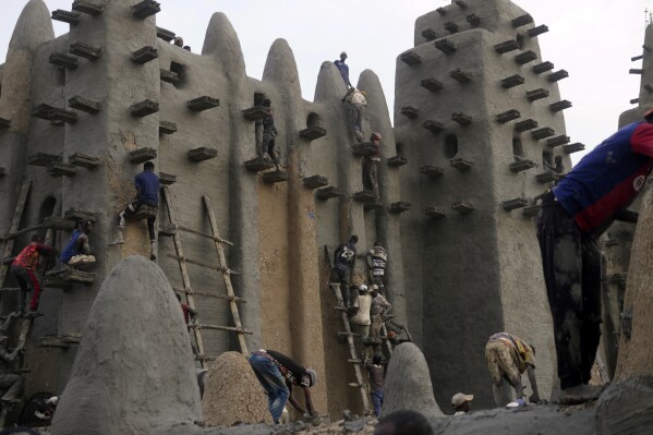 Malians take part in the annual replastering of the world's largest mud-brick building, the Great Mosque of Djenne, Mali, Sunday, May 12, 2024. The building has been on UNESCO's World Heritage in Danger list since 2016. The mosque and surrounding town are threatened by conflict. Djenne's mosque requires a new layer of mud each year before the start of the rainy season in June. (Ǻ Photo/Moustapha Diallo)