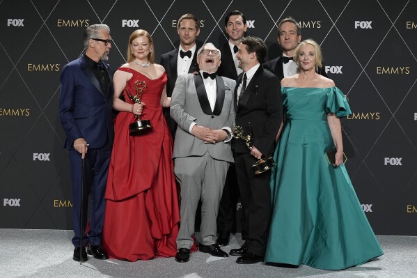 Alan Ruck, from left, Sarah Snook, Alexander Skarsgard, Brian Cox, Nicholas Braun, Kieran Culkin, Matthew Macfayden, and J. Smith-Cameron, winners of the award for outstanding drama series for "Succession," pose in the press room during the 75th Primetime Emmy Awards on Monday, Jan. 15, 2024, at the Peacock Theater in Los Angeles. (AP Photo/Ashley Landis)