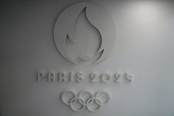FILE - The logo of the Paris 2024 Organizing Committee, is pictured at the headquarters in Saint Denis, outside Paris, Thursday, Oct.14, 2021. China lost its Paris Olympics place in team eventing to be staged at the Versailles Palace because of a positive test by the horse of a three-time Olympian, it was announced Wednesday, Oct. 11, 2023. Japan will replace China. (AP Photo/Francois Mori, file)