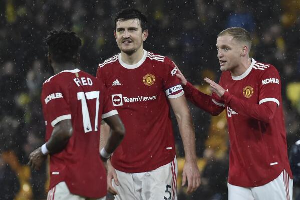 Manchester United's Harry Maguire, centre and Donny van der Beek, right, reacts alongside Fred during the English Premier League soccer match between Norwich City and Manchester United at Carrow road in Norwich, England, Saturday, Dec.11, 2021. (AP Photo/Rui Vieira)