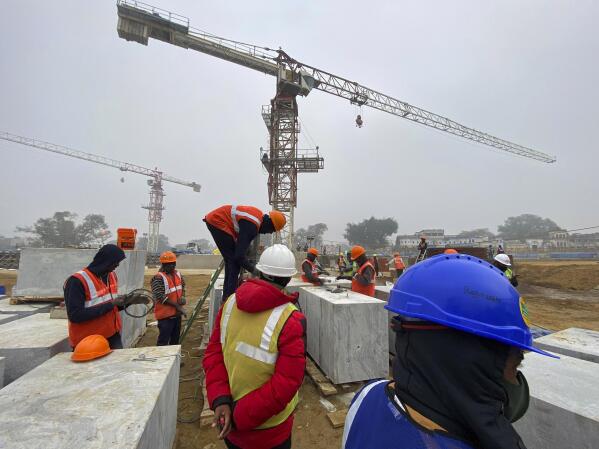 Laborers build a Hindu temple dedicated to Hindu god, Ram, demanded by millions of Hindus for over 100 years in Ayodhya, in the Indian state of Uttar Pradesh, Feb. 3, 2022. It's one of several frenetic constructions underway in Ayodhya, where Prime Minister Narendra Modi's Bharatiya Janata Party is seeking reelection by touting Hindu-first politics coupled with economic prosperity. Over 150 million people are expected to vote in the state across seven phases starting Thursday before results are declared in March. (AP Photo/Rajesh Kumar Singh)
