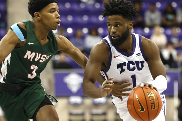 TCU guard Mike Miles Jr. (1) handles the ball as Mississippi Valley State guard Kadar Waller (3) defends during the second half of an NCAA college basketball game, Sunday, Dec. 18, 2022, in Fort Worth, Texas. (AP Photo/Ron Jenkins)